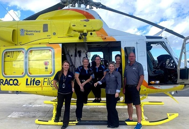 Team standing with the RACQ LifeFlight helicopter